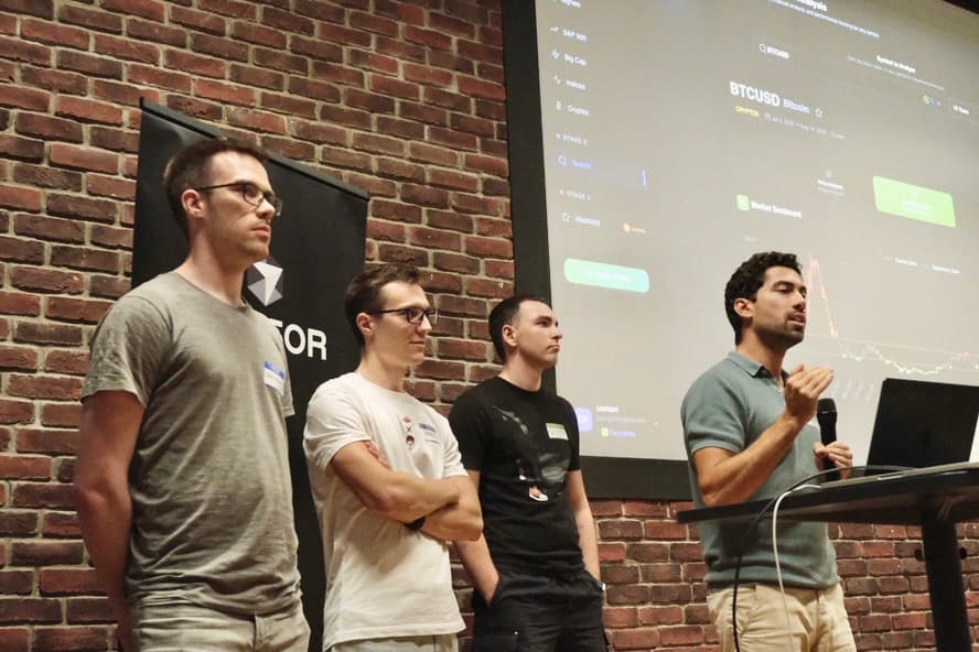 BetterBuyLow being presented on stage, the app on the screen behind